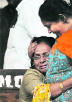 Relatives of a blast victim mourn at a hospital in Pune on Sunday.