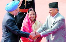 Prime Minister Manmohan Singh greets Nepal President Ram Baran Yadav while President Pratibha Patil looks on at Rashtrapati Bhawan in New Delhi on Tuesday.