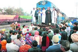 Angry over disrespect to Jesus Christ in a poster, protesters stop a train at Bathinda on Saturday.