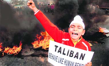 A Sikh boy protests against Talibans act of killing Sikhs in Pakistan, in Jammu on Tuesday.