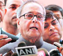 Finance Minister Pranab Mukherjee addressing the media outside Parliament in New Delhi on Thursday.