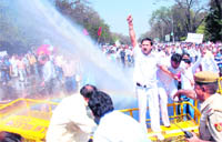 The police uses a water cannon to disperse BJP activists protesting against hike in fuel prices, in New Delhi 