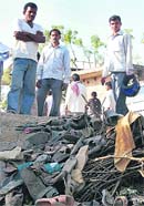 Locals gather near the stampede site at an ashram in Kunda, Uttar Pradesh, on Thursday.