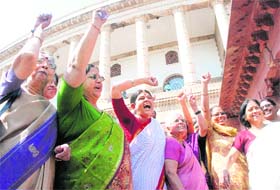 Women activists shout slogans outside Parliament