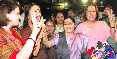 Leader of the Opposition in Lok Sabha Sushma Swaraj, Brinda Karat (CPM) and Najma Heptulla (BJP) show a victory sign after the Womens Reservation Bill was passed in Rajya Sabha in New Delhi on Tuesday.