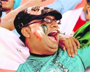 A fan cheers the teams during the match.