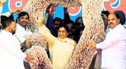 BSP supremo Mayawati being garlanded by party workers during a rally, organised to mark BSPs silver jubilee celebrations, in Lucknow on Monday.