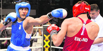 Vijender Singh punches his opponent Frank Buglioni of England in the final of the middle 75 kgs category at Commonwealth Boxing Championship in New Delhi on Wednesday. Vijender won the match. Five other 