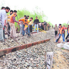 Northern Railway workers repairing the railway track near Galbaugh in south Kashmirs Pulwama district. the track was damaged in an IED blast last night.