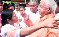 Union Railway Minister Mamata Banerjee interacts with RJD leader Lalu Prasad Yadav after attending the all-party meeting in the Parliament on the Womens Reservation Bill.