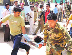 An injured soldier is carried for treatment after a Maoist attack in Chhattisgarh on Tuesday.