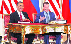 US President Barack Obama (L) and Russian President Dmitry Medvedev smile after signing the new Strategic Arms Reduction Treaty (START II) in Prague on Thursday.