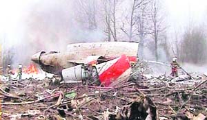 Firefighters try to douse the flames near the wreckage of Tupolev Tu-154 aircraft near Smolensk airport in Western Russia on Saturday.
