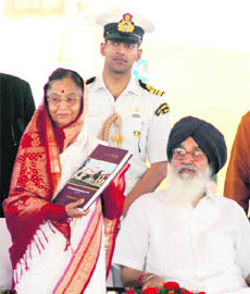 President Pratibha Devisingh Patil shows the coffee book presented to her as Punjab CM Parkash Singh Badal looks on at a function to mark Golden Jubilee celebrations of PPS, Nabha, on Monday