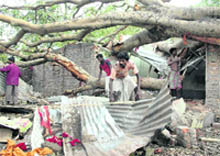 Residents try to erect their damaged houses in Fatepur village after a storm hit North Dinajpur district of West Bengal 