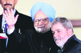Prime Minister Manmohan Singh waves as he stands with Brazils President Luiz Inacio Lula da Silva at Itamaraty Palace in Brasilia