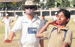 Dinesh Mongia trains a boy on the DAV College ground in Chandigarh.
