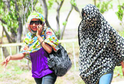 Sweltering heat forces these girls to cover themselves in Chandigarh on Friday.