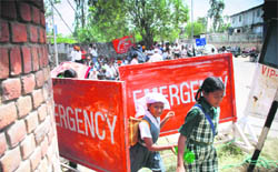Schoolchildren pass through a barricade as employees of the PSEB protest in Mohali on Friday. Power consumers, who had to deposit their bills, were particularly harassed due to heavy barricading along with other factors.