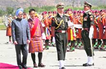 Prime Minister Manmohan Singh along with his Bhutanese counterpart Jigme Y Thinley inspects the guard of honour on his arrival at Paro Airport in Thimphu