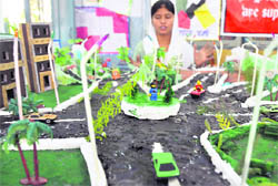 A girl displays a model during the three-day district-level exhibition in Ludhiana.