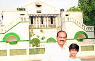 Raj Chengappa in front of the military hospital in Ferozepur where he was born, with his son Aneesh