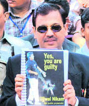 Special public prosecutor Ujjawal Nikam shows copy of the verdict in 26/11 case in Mumbai on Monday.