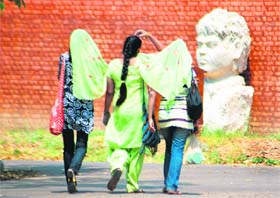 Camaraderie comes to the fore as these students of the Government College of Art protect themselves from the sun.