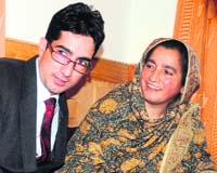 Dr Shah Faesal with his mother Mubeena Bano at his home in Srinagar on Saturday.
