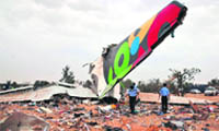 Rescue teams search the site of the Libyan Afriqiyah Airways plane crash in Tripoli 