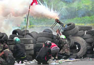 Anti-government protesters fire home-made rockets on a Thai soldier in Bangkok 