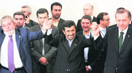 Iranian President Mahmoud Ahmadinejad (C), his Brazilian counterpart Luiz Inacio Lula da Silva (L) and Turkish Prime Minister Tayyip Erdogan (R) wait for the signing of agreement ceremony during the G-15 in Tehran on Monday.