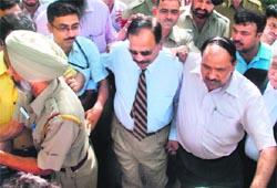Haryana ex-DGP SPS Rathore being taken into custody by CBI officials at a Chandigarh court on Tuesday.