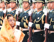 President Pratibha Patil inspects guard of honour during a welcome ceremony inside the Great Hall of the People in Beijing on Thursday.