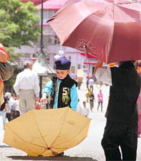 Umbrellas came out as the day temperature soared in Shimla on Thursday.