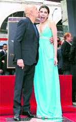 Actor Ben Kingsley kisses his wife Daniela Lavender as they stand on his star on the Walk of Fame in Hollywood, California on Thursday