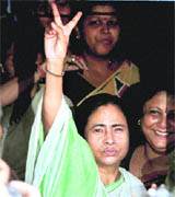 Trinamool Congress chief Mamata Banerjee flashes the victory sign in Kolkata on Wednesday.