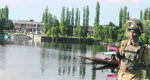 A jawan keeps vigil on the banks of the Dal Lake in Srinagar on Sunday.
