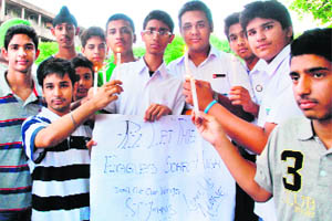 Students of St Johns High School take out a candlelight march in Chandigarh on Tuesday.