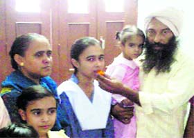 Amandeep Kaur, who secured top position in the PSEB class X examination, celebrates with her family
