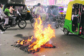 An effigy that was left burning pose a danger to the commuters in Ludhiana on Monday.