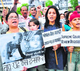 Members of various social organisations of the tricity carry placards seeking strict action against those involved in the Bhopal Gas Tragedy.