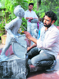Artist Harpal gives finishing touches to a sculpture at Punjab Kala Bhawan-16 on Tuesday