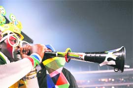 A fan blows a vuvuzela