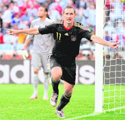 Germanys Miroslav Klose celebrates after scoring his sides second goal during the World Cup quarterfinal match against Argentina in Cape Town on Saturday. Germany won 4-0.