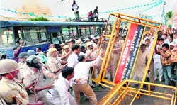 BJP activists clash with the police in Lucknow during the Bharat Bandh called by various political parties against price rise on Monday.
