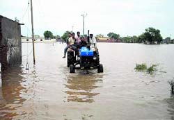 Tractor ferries people to their destination at Diwala village