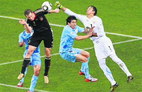 Germany's Marcell Jansen (L) heads the ball to score against Uruguay during the World Cup third place playoff match in Port Elizabeth on Saturday. Germany beat Uruguay 3-2.