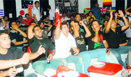 Fans cheer their favourite teams during the Football World Cup final, at a hotel in Chandigarh on Monday