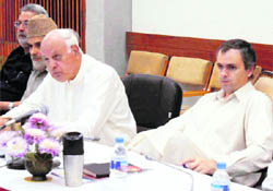 J&K Chief Minister Omar Abdullah is flanked by his father and NC chief Farooq Abdullah at the all-party meeting in Srinagar on Monday.